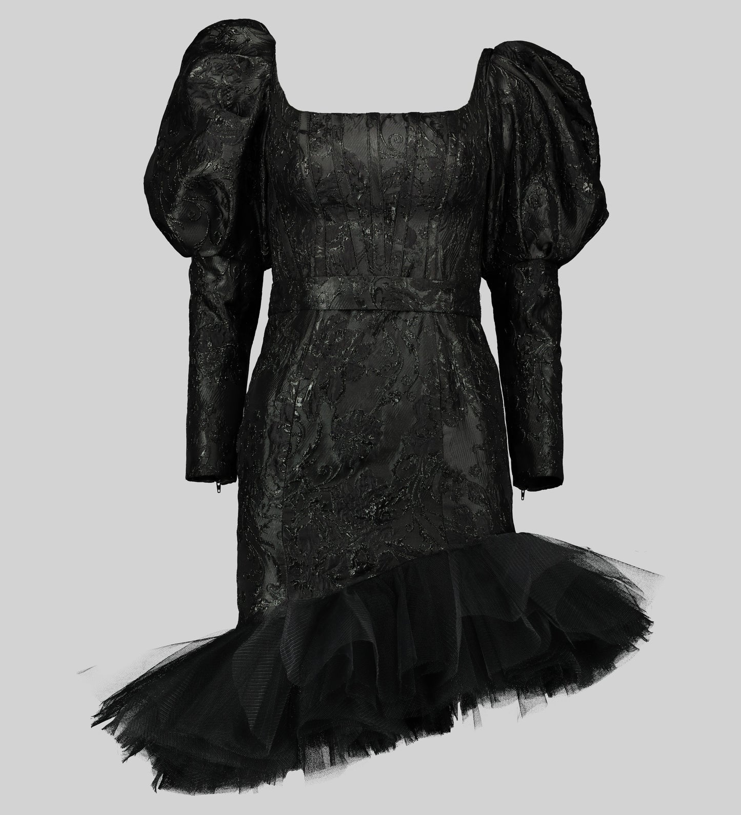 Black cocktail dress with a square neckline and mutton sleeves. The bodice is made of opulent brocade fabric, while the skirt features a whimsical layered tulle with an asymmetrical hem.