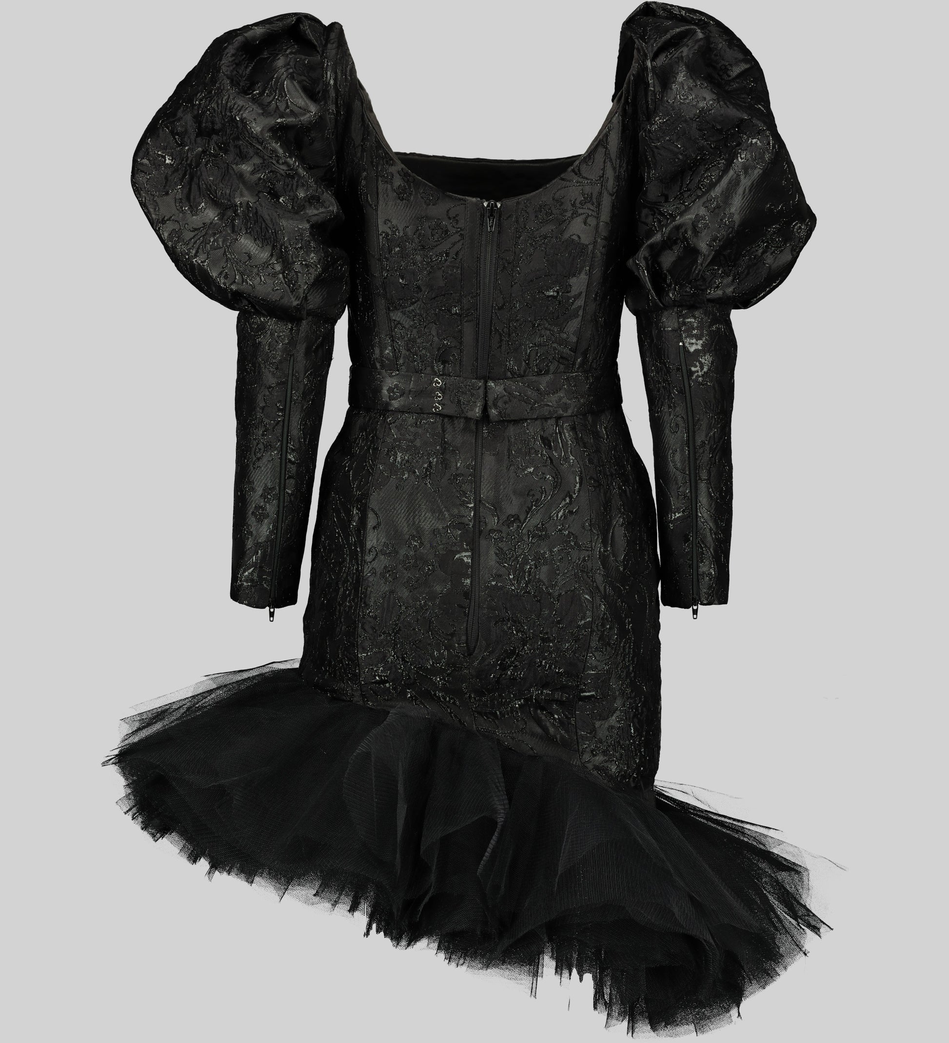 Black cocktail dress with a square neckline and mutton sleeves. The bodice is made of opulent brocade fabric, while the skirt features a whimsical layered tulle with an asymmetrical hem.