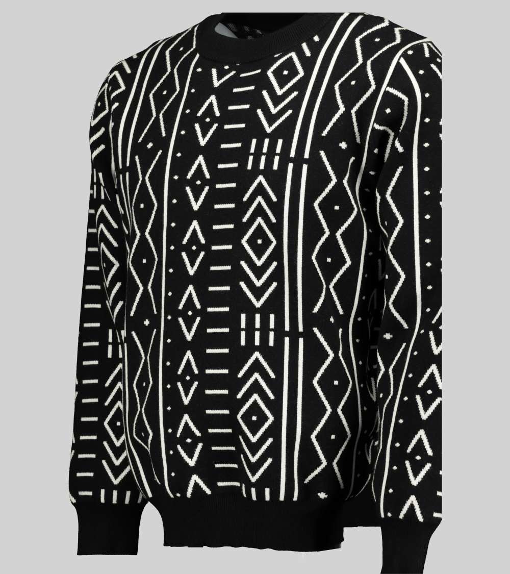 Black and white African print knit sweater with a boxy fit and long sleeves. This view showcases the drape and flow of the sweater.