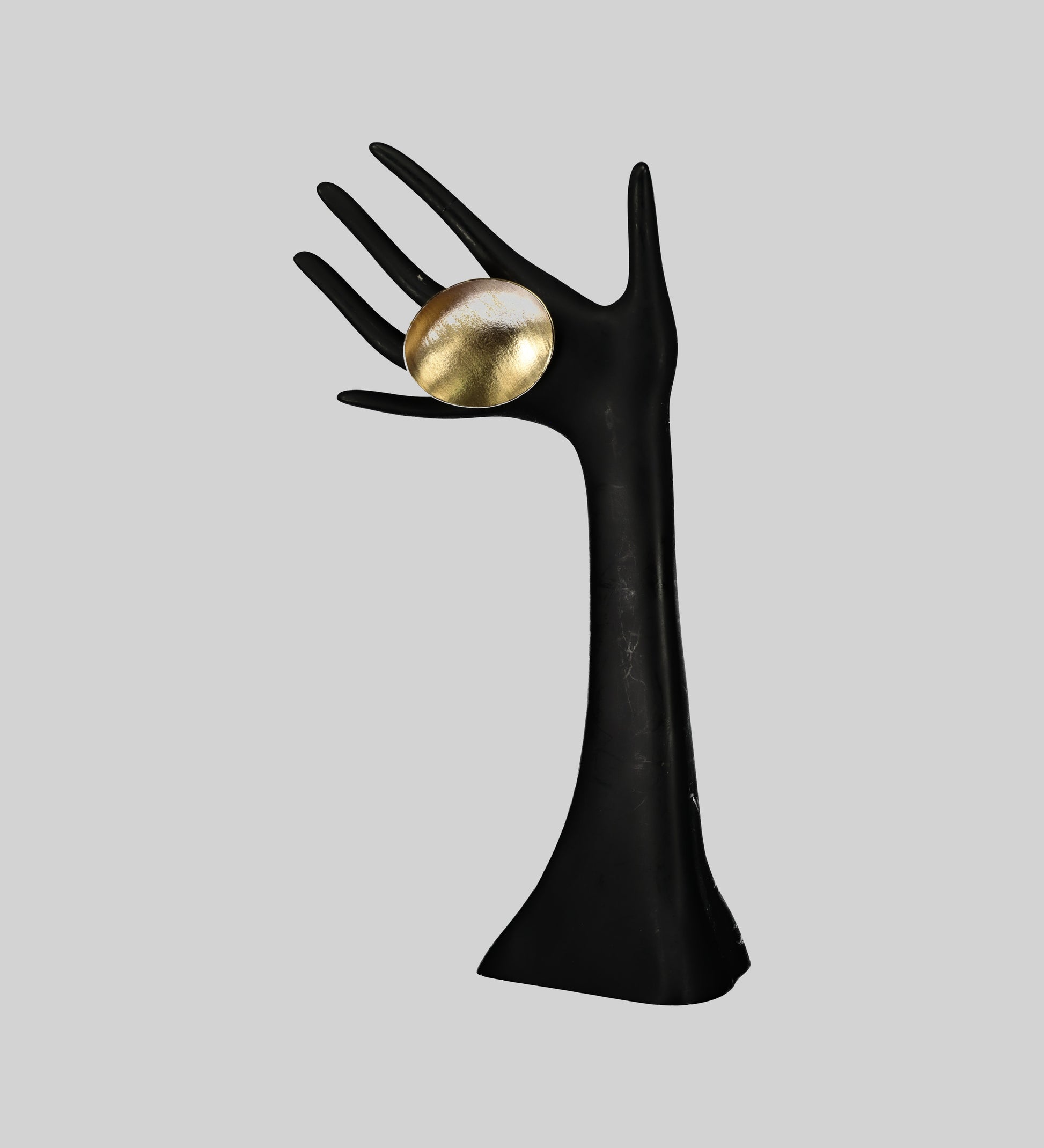 Ditsala Designs Gold Metal Ring on a Black Hand Mannequin.