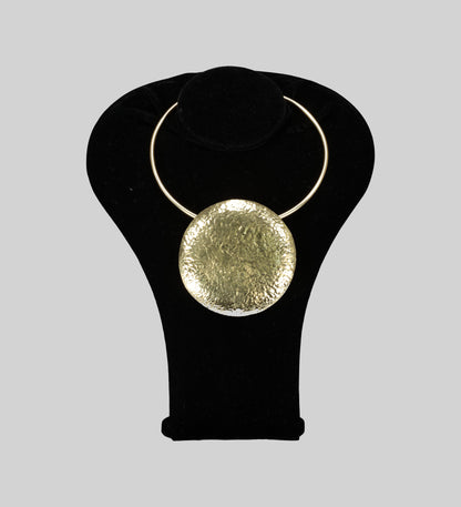 Front view of the gold disk-like Crafted in lustrous gold and adorned with a unique circle front detail, this neckpiece exudes elegance and style.