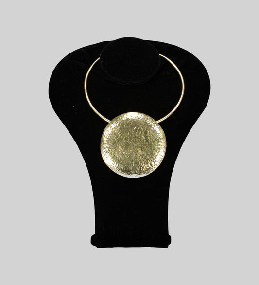 Front view of the gold disk-like Crafted in lustrous gold and adorned with a unique circle front detail, this neckpiece exudes elegance and style.